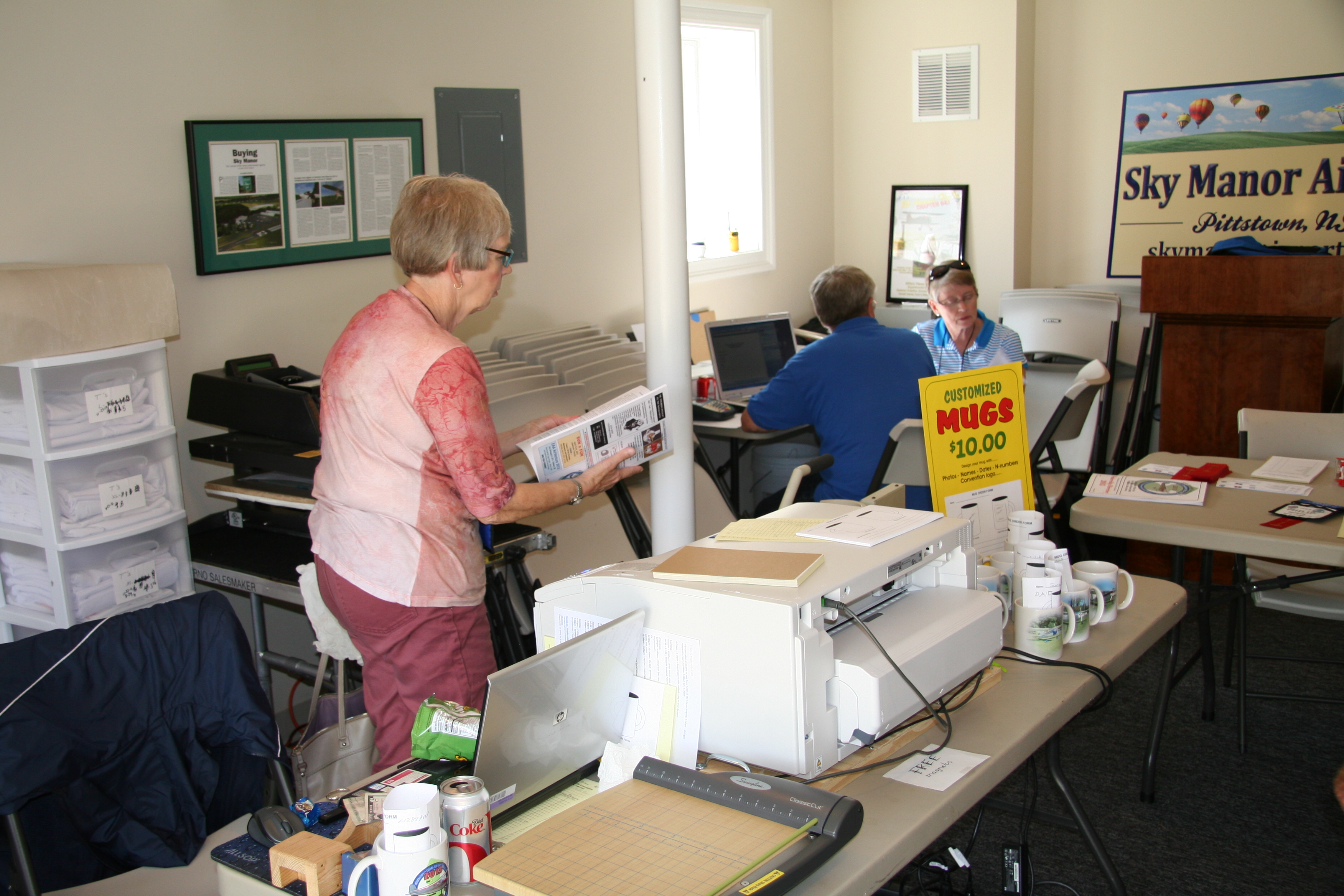 Joy working the table at Pittstown NJ, 2013, Dick and Nicki Acker in the background
